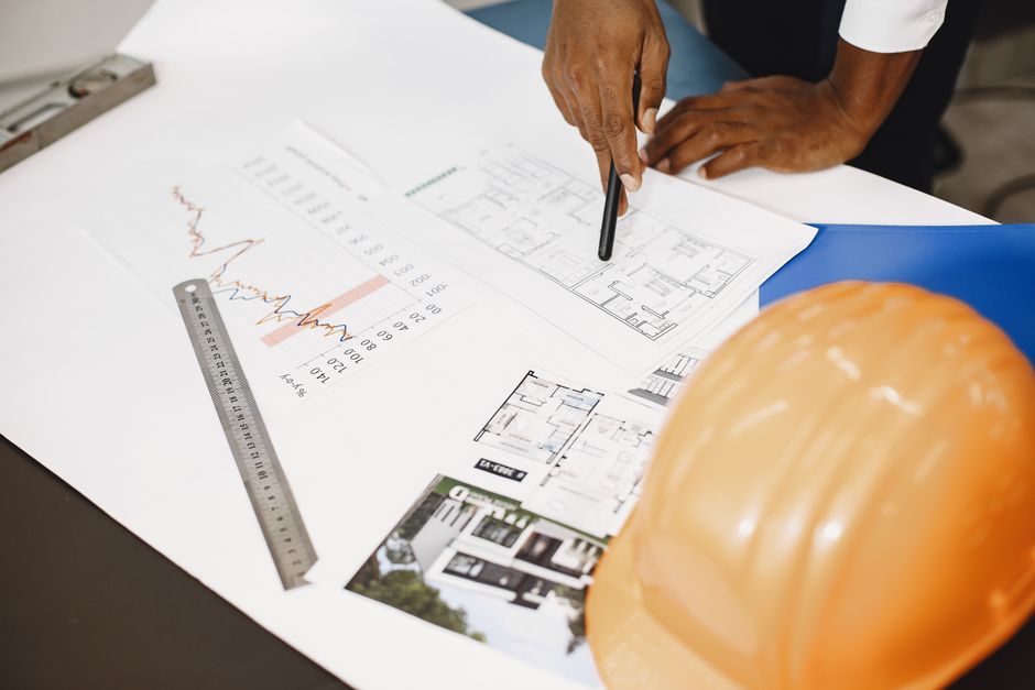 Hands holding architectural blueprints and project specifications